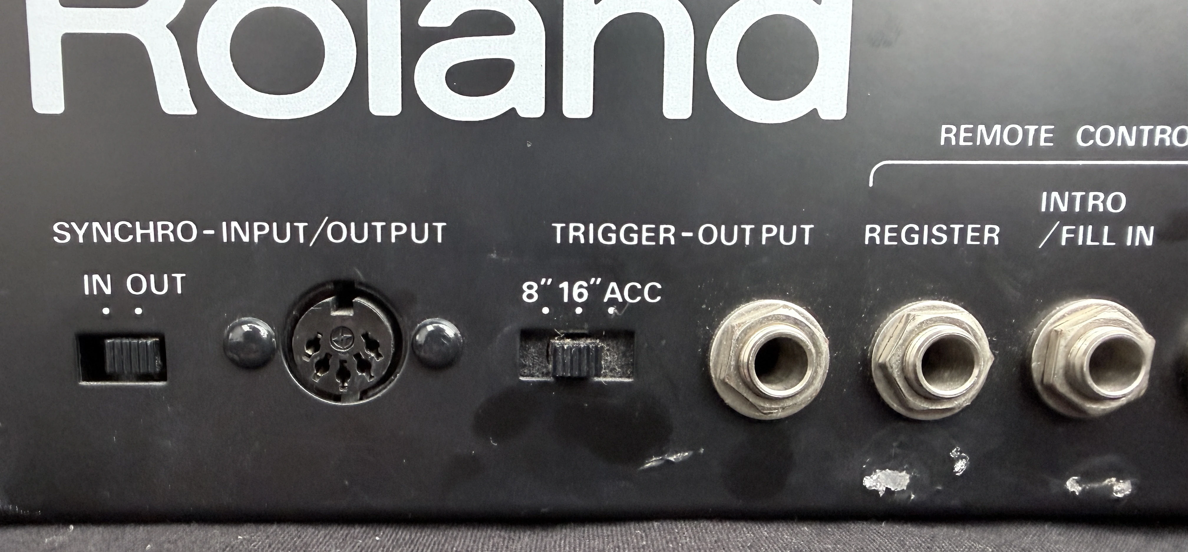 CR-8000 rear-panel detail showing Roland branding, DIN Sync input and output, Trigger Out, Register and Intro Fill In sockets