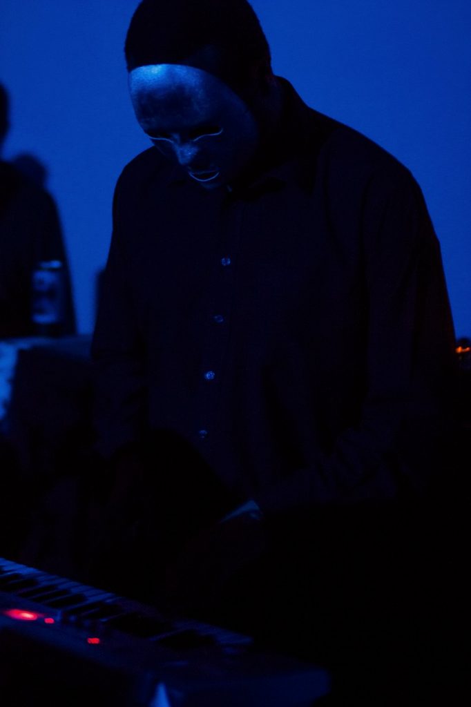 Drexciya member Gerald Donald performing under blue stage light