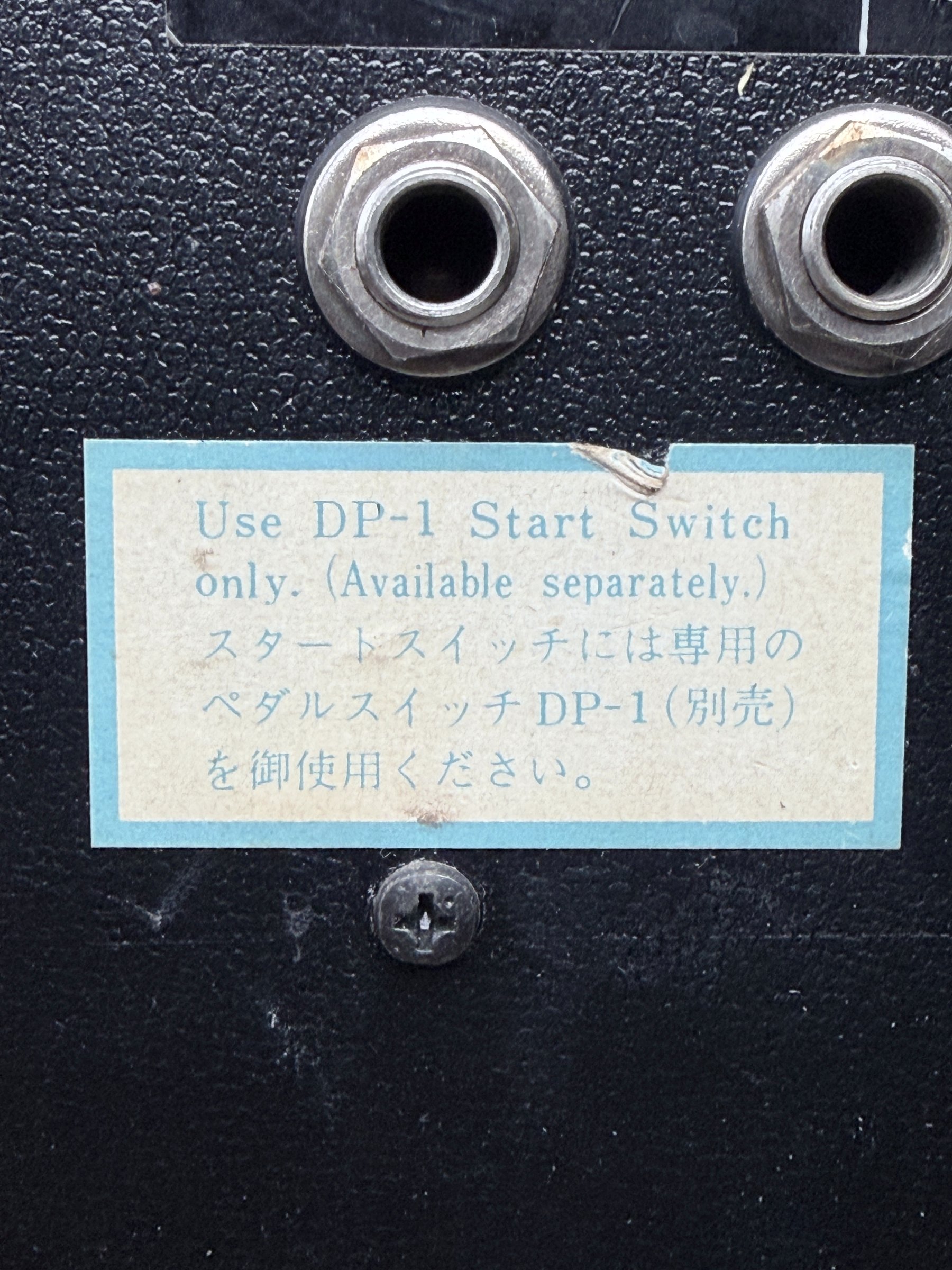 Surviving bilingual label instructing the TR-66 owner to use the separately available Roland DP-1 start switch