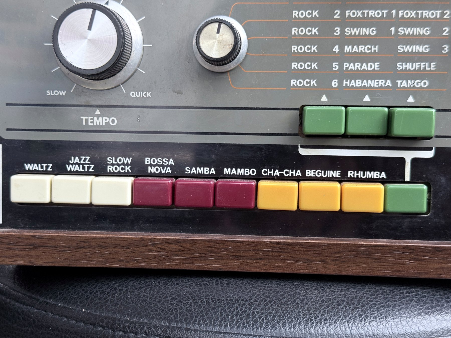 Close view of the TR-66 lower rhythm bank and three green upper-programme selector buttons