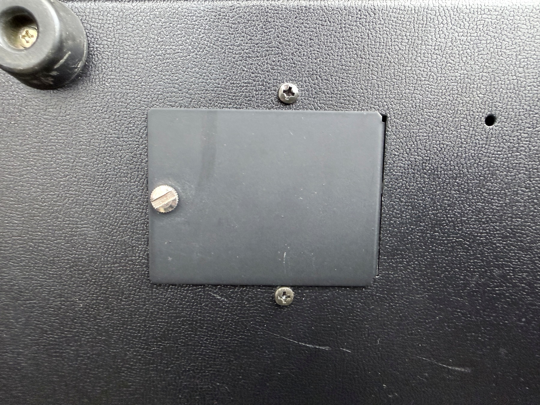 Close photograph of the original TR-808 battery compartment door and cabinet texture