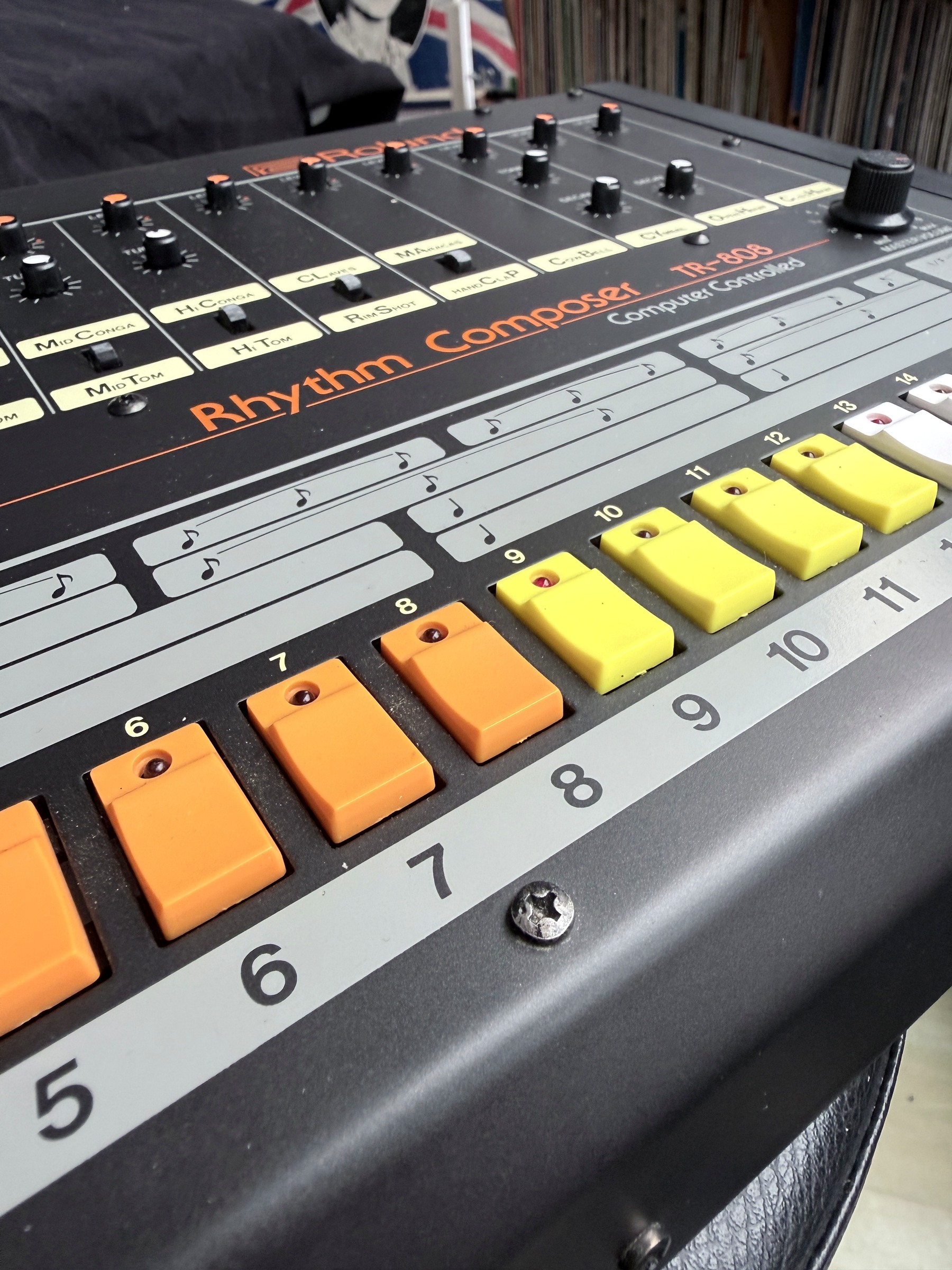 Angled detail of the TR-808 voice controls and coloured step keys