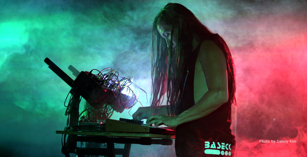Baseck performing with electronic equipment in Sequential’s artist profile.