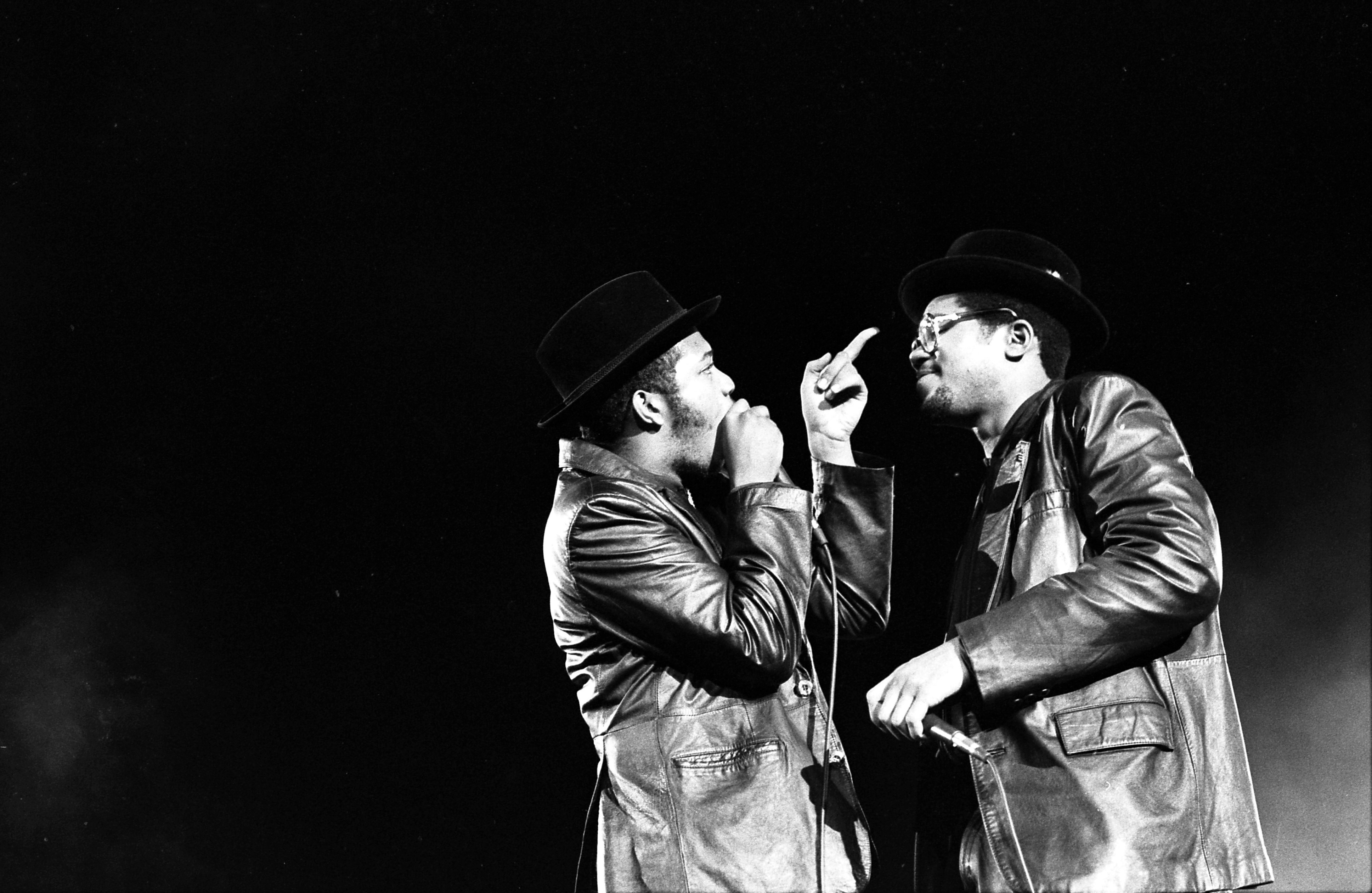 Joseph Run Simmons and Darryl D.M.C. McDaniels of Run-D.M.C. performing at Long Beach Arena in 1984, photographed by Ian Dryden.