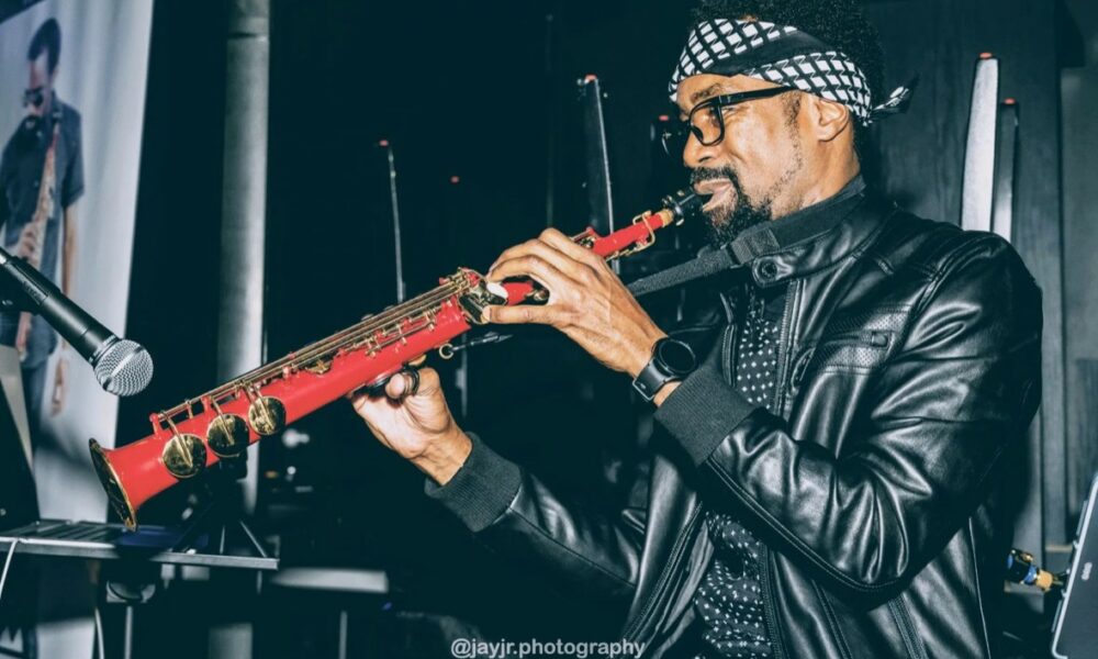 Tadric Jermaine performing saxophone in a VoyageATL feature photograph.